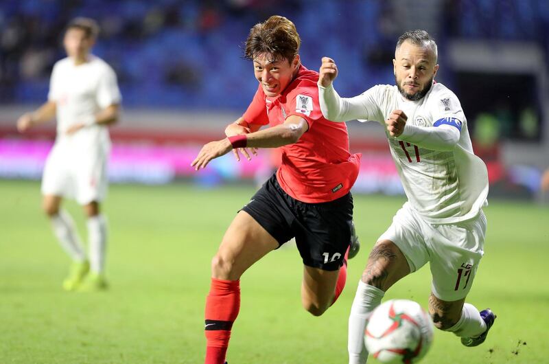 DUBAI , UNITED ARAB EMIRATES , January  7 – 2019 :- Hwang Uijo ( no 18 in red ) of Korea Republic and Stephan Schrock ( no 17 in white ) of Philippines in action during the AFC Asian Cup UAE 2019 football match between KOREA REPUBLIC vs. PHILIPPINES held at Al-Maktoum Stadium in Dubai. Korea Republic won the match by 1-0. Hwang Uijo scored the goal against Philippines. ( Pawan Singh / The National ) For News/Sports