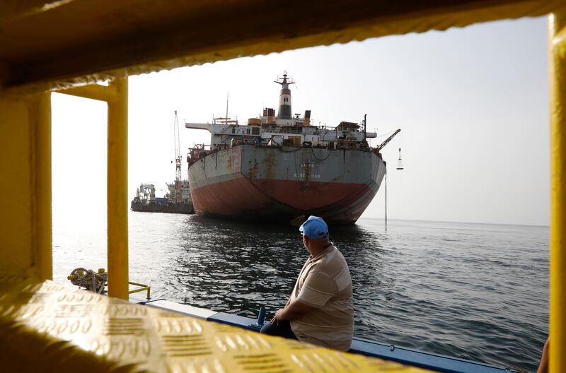 A UN staff looks at FSO Safer oil tanker moored in the Red Sea, off the coast of the western Hodeidah province, Yemen, 15 July 2023.  The transfer of 1. 14 million barrels of oil from the 47-year-old FSO Safer supertanker, stranded off Yemen's Red Sea coast since 1988, will begin next week after the UN-purchased vessel sailed from Djibouti en route to the Safer site, the United Nations has reported.  The Nautica is a super-tanker the UN purchased for taking the crude oil from the decaying FSO Safer.  The beleaguered FSO Safer has not undergone maintenance since Yemen's war broke out in 2015 and was left abandoned off the Houthis-held port of Hodeidah in the Red Sea, posing a serious risk to the environment off the coast of Yemen due to the possibility of it breaking up or catching fire.   EPA / YAHYA ARHAB