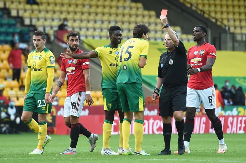 Norwich City's Timm Klose is shown a red card by referee Jon Moss. Reuters