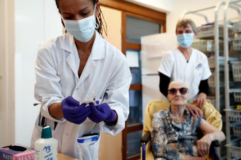 A doctor prepares a dose of the Pfizer-BioNTech vaccine for a resident at Antoine Balmes hospital in Montpellier, France. EPA