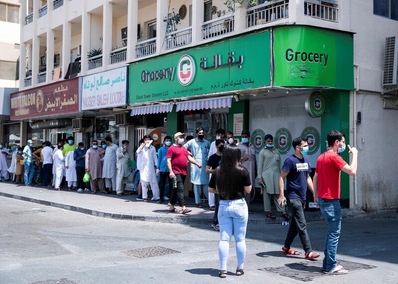 DUBAI, UNITED ARAB EMIRATES. 18 June 2020. 
Pakistani citizens who live in Dubai line up outside Dnata. They’ve received a confirmation call from the consulate regarding their repatriation flights. Some are flying back tonight.
(Photo: Reem Mohammed/The National)

Reporter:
Section: