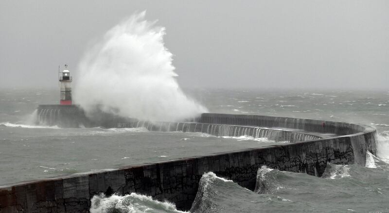 Waves crash over Newhaven Lighthouse as Storm Barra passes through southern England. AFP