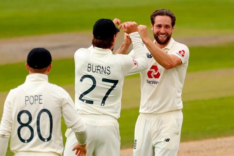 England bolwer Chris Woakes, right, celebrates with teammates after taking the wicket of Pakistan's Mohammad Rizwan. AFP