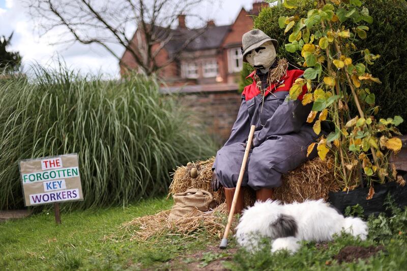 A scarecrow is pictured outside a house during the Scarecrow Competition, after the annual Betley Show was cancelled in Britain. Reuters