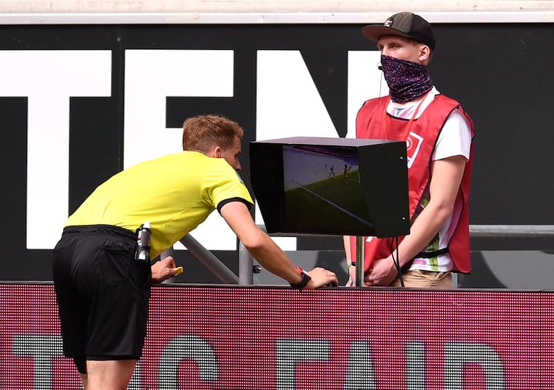 Referee Soren Storks refers to VAR during the Dusseldorf-Hoffenheim game. Reuters