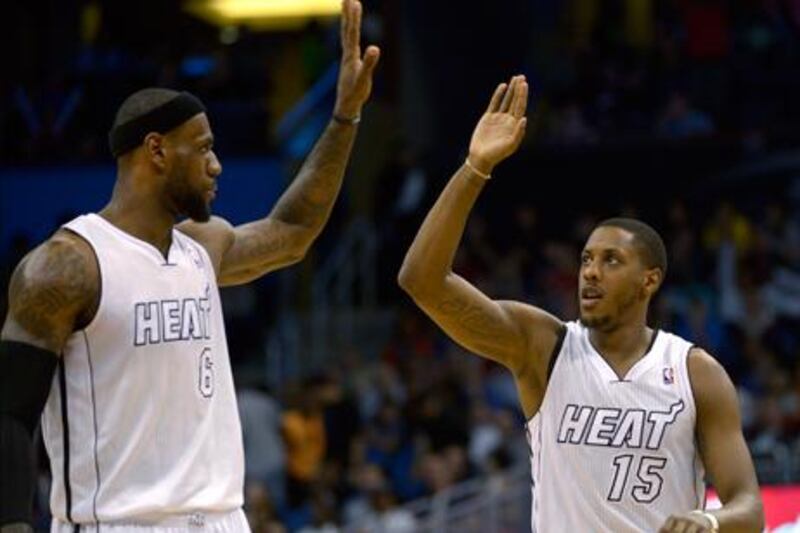 Miami Heat's Mario Chalmers is congratulated by LeBron James after his basket against Orlando Magic