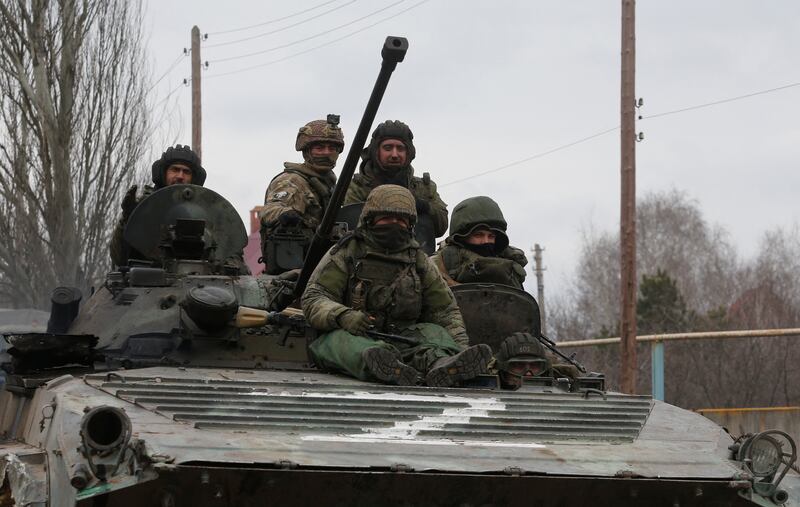 Pro-Russian troops in uniforms without insignia in an armoured vehicle with "Z" painted on its front in Donetsk, Ukraine. Reuters