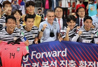 South Korea manager Paulo Bento celebrates with his players after qualifying for the Qatar World Cup. EPA