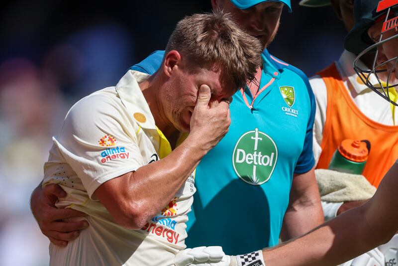 David Warner is assisted from the field as he retires injured after reaching  his double century. AP