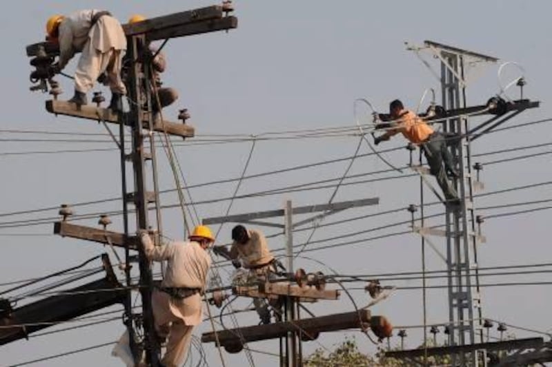 Pakistani technicians work on high voltage power lines in Lahore. The Peshawar Electric Supply Company (Pesco) has taken out front page advertisements in major newspapers reminding readers that stealing electricity is a sin.