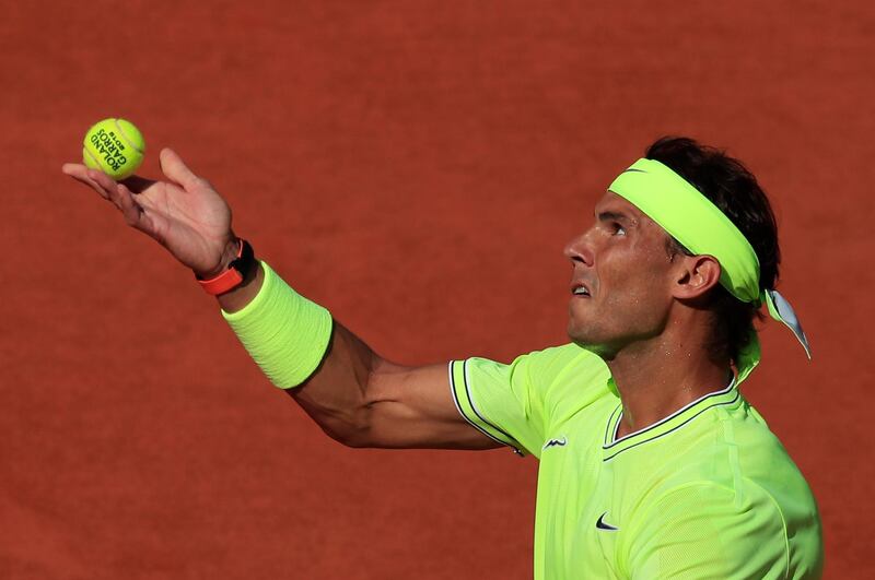 Nadal examines a ball., Reuters