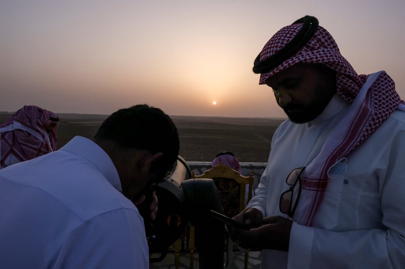 A member of the moon-sighting committee uses a telescope to view the moon ahead of Ramadan, in Tumair, Saudi Arabia, on April 1, 2022.  Reuters