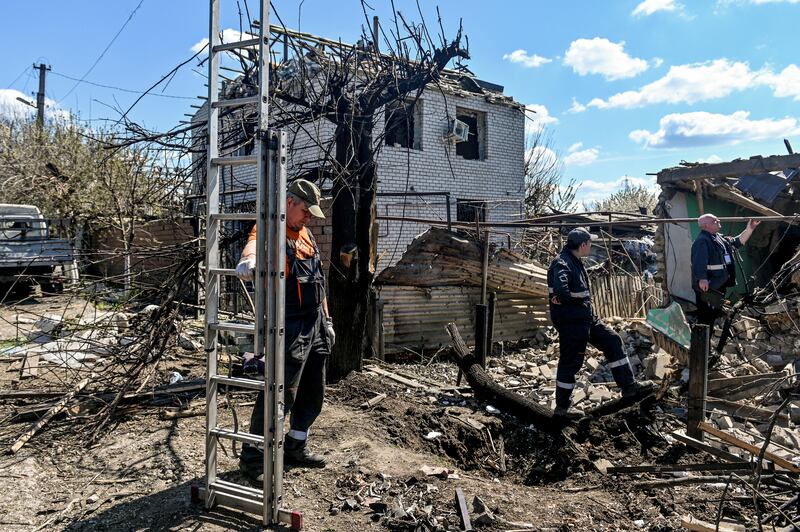 Emergency workers at the site of houses damaged by a missile attack in Zaporizhzhia, Ukraine. Reuters