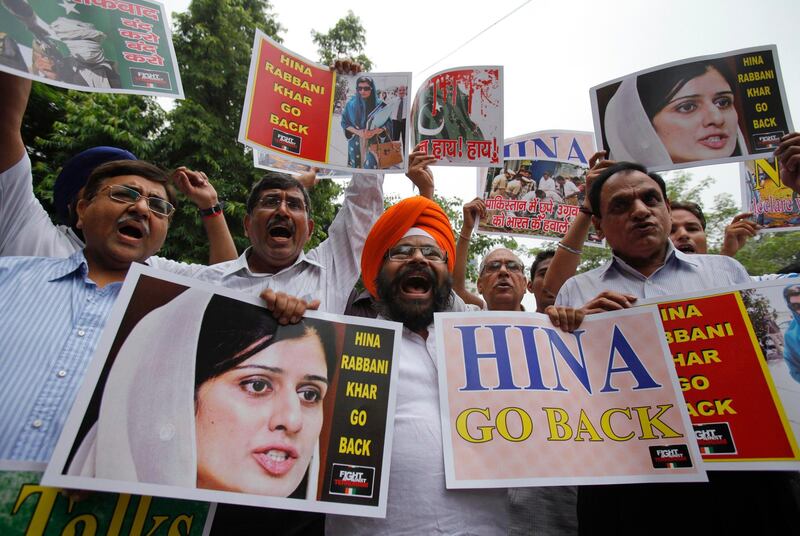 Members of the Fight against Terrorism Society hold posters and shout slogans during a protest against the visit of Pakistan's Foreign Minister Hina Rabbani Khar to India, in New Delhi July 27, 2011. Indian and Pakistani foreign ministers said on Wednesday they have a responsibility to mend ties between the nuclear-armed rival countries to reduce tension in the region, made all the more urgent with a U.S. troops drawdown in Afghanistan looming. REUTERS/Adnan Abidi (INDIA - Tags: POLITICS CIVIL UNREST)