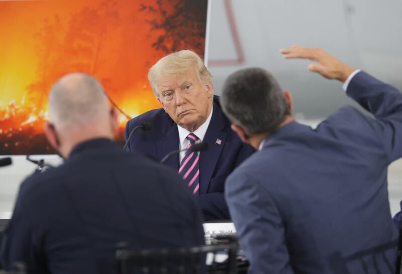 US President Donald Trump listens during a briefing on wildfires in McClellan Park, California. REUTERS