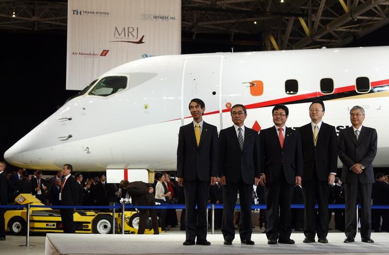Mitsubishi Aircraft president Teruaki Kawai, left, All Nippon Airways CEO and president Shinichiro Ito, second left, Japanese deputy land, infrastructure, transport and tourism minister Akihiro Nishimura, centre, Japanese deputy education, culture, sports and science minister Hideki Niwa, second right, and Mitsubishi Heavy Industrires chairman Hideaki Omiya, right, pose in a photo session during a ceremony of the Mitsubishi Regional Jet. Toshifumi Kitamura / AFP