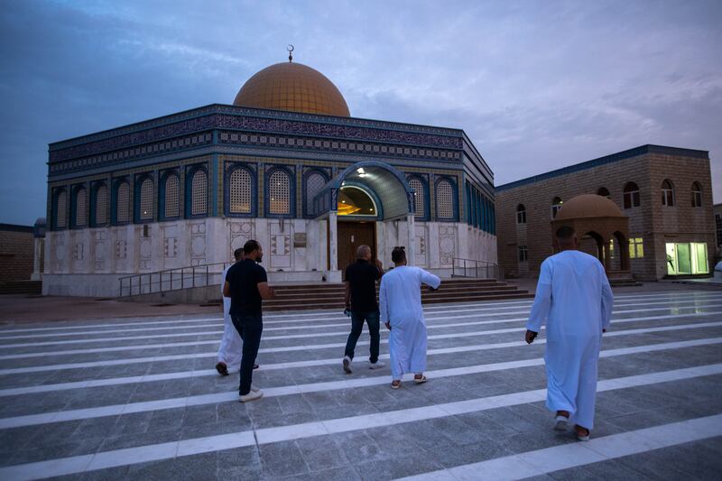 Worshippers arrive on the first morning of Eid Al Adha at Bani Hashim Mosque in Abu Dhabi. Victor Besa / The National