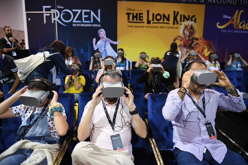 Attendee try the Disney on Broadway virtual reality experience at the D23 Expo, billed as the "largest Disney fan event in the world," August 23, 2019 at the Anaheim Convention Center in Anaheim, California. Disney Plus will launch on November 12 and will compete with out streaming services such as Netflix, Amazon, HBO Now and soon Apple TV Plus. / AFP / Robyn Beck
