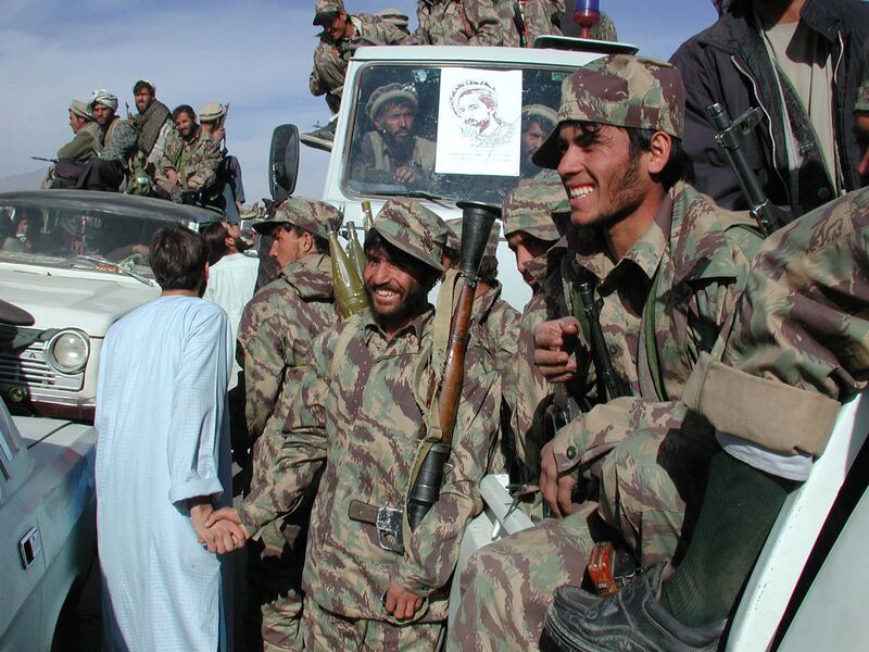 Fighters from the Afghan opposition Northern Alliance celebrate the
withdrawal of the Taliban in November 2001.