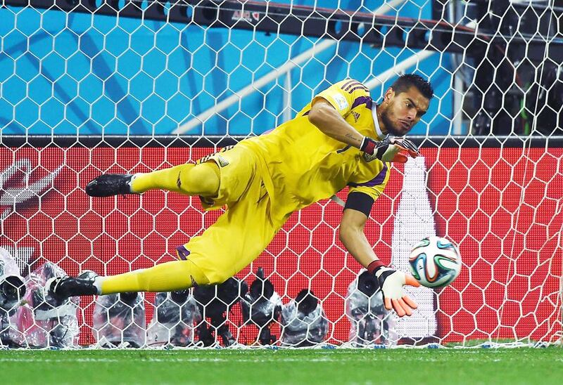 Argentina goalkeeper Sergio Romero makes a save from Netherlands defender Ron Vlaar during a penalty shoot-out in their World Cup semi-final at The Corinthians Arena in Sao Paulo on July 9, 2014. Pedro Ugarte / AFP