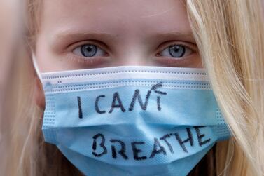 A young woman wears a facemask as people gather at the Alexander Platz in Berlin, Germany, to protest against the killing of George Floyd. AP Photo