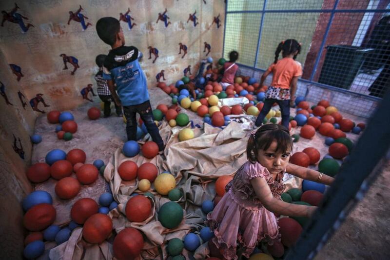 Syrian children play in a ball pen during the second day of Eid Al Adha in Douma, outside Damascus, Syria.  Mohammed Badra / EPA