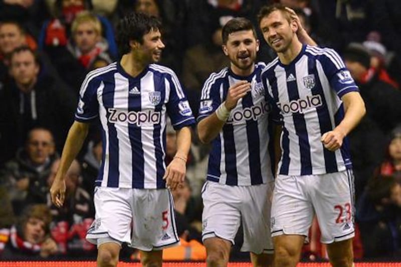 West Bromwich Albion defender Gareth McAuley (r) celebrates his goal against Liverpool with teammates Claudio Yacob and Shane Long.