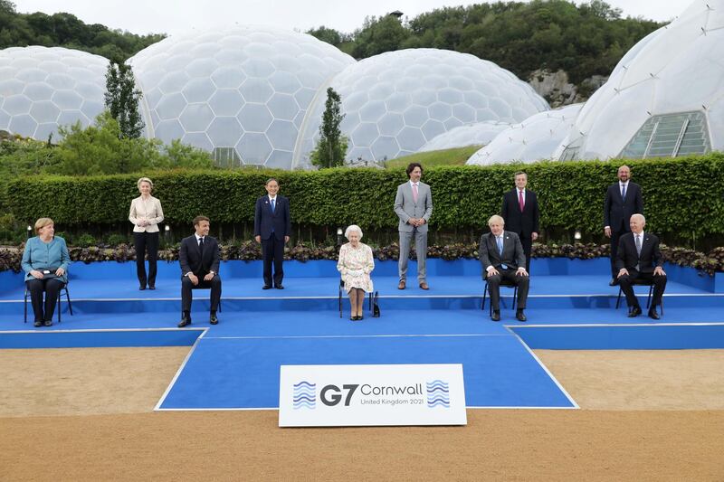 From left to right, German Chancellor Angela Merkel, European Commission President Ursula von der Leyen, France's President Emmanuel Macron, Japan's Prime Minister Yoshihide Suga, Queen Elizabeth II, Canada's Prime Minister Justin Trudeau, Britain's Prime Minister Boris Johnson, Italy's Prime Minister Mario Draghi,  European Council President Charles Michel and US President Joe Biden pose for a group photograph during a reception on the sidelines of the G7 summit in Cornwall. Reuters