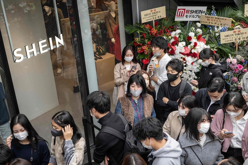 People queue outside the first permanent showroom of Chinese online fast fashion giant Shein on the opening day of the shop in Tokyo on November 13. Shein is the most Googled fashion brand in the world in 2022, according to a survey by money.co.uk. AFP