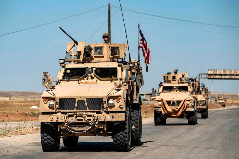 SYRIA: US military vehicles drive in a patrol along the M4 highway by the town of Tal Tamr and its countryside in Syria's northeastern Hasakeh province, near the border with Turkey, on May 20, 2020. AFP
