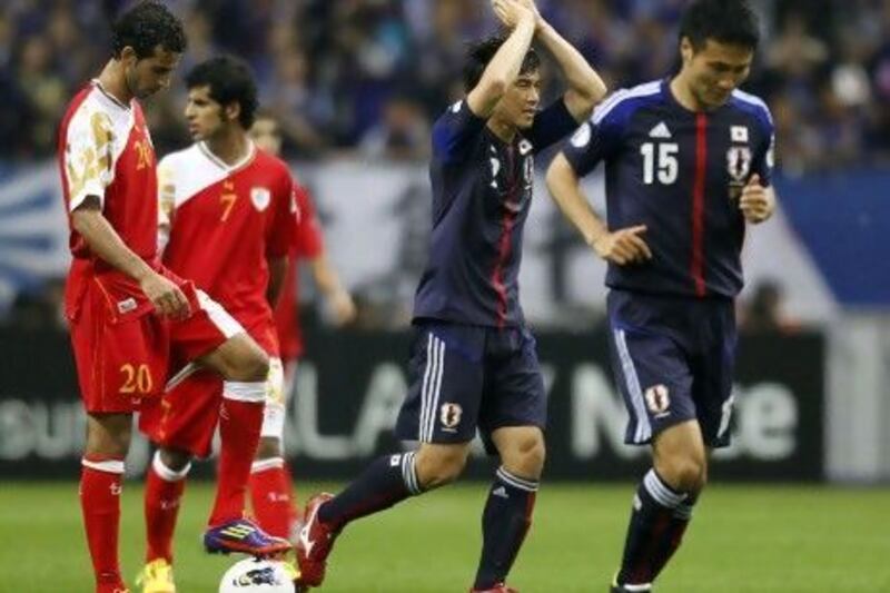 Japan's Shinji Okazaki, second right, celebrates his goal against Oman.