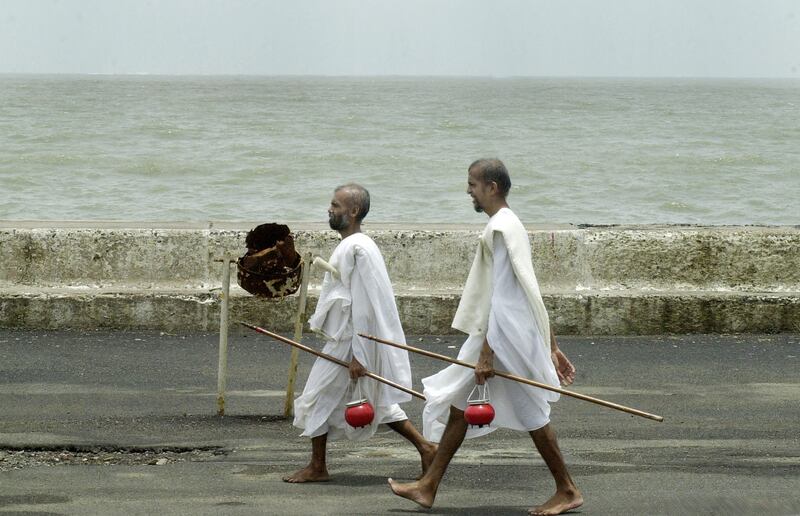 Jain monks, pictured here on a promenade in the Indian city of Mumbai in 2003, always walk barefoot, spreading a message of peace and non-violence.