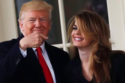 U.S. President Donald Trump reacts as he stands next to former White House Communications Director Hope Hicks outside of the Oval Office as he departs the White House for a trip to Cleveland, Ohio, in Washington D.C., U.S., March 29, 2018. Picture taken March 29, 2018. REUTERS/Carlos Barria