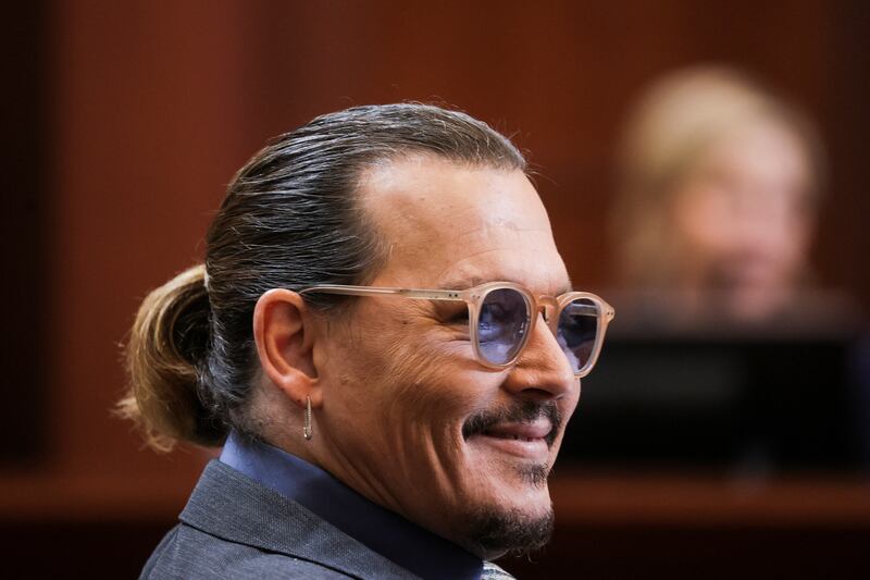 Depp reacts while clinical and forensic psychologist Dr Shannon Curry gives evidence. Reuters