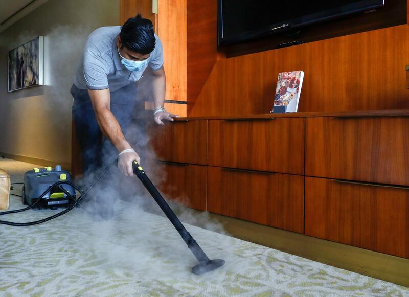 Abu Dhabi, United Arab Emirates, August 12, 2020.   
Media Tour at The Westin Abu Dhabi Golf Resort & Spa on how tourism officials are conducting the go safe certification for hotels against Covid-19.  A hotel cleaner steams the carpet of a room.
Victor Besa /The National
Section:  NA
Reporter:  Haneen Dajani