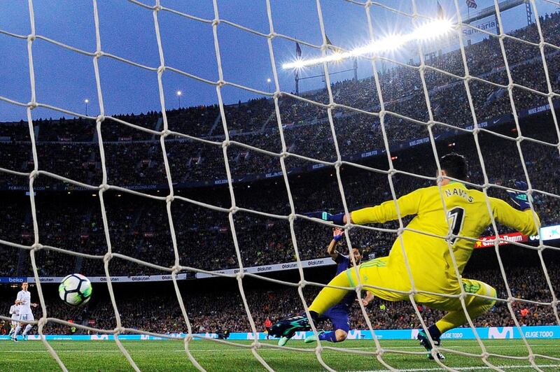 Barcelona's Uruguayan forward Luis Suarez (2R) shoots and score a goal during the Spanish league football match between FC Barcelona and Real Madrid CF at the Camp Nou stadium in Barcelona on May 6, 2018. (Photo by Josep LAGO / AFP)