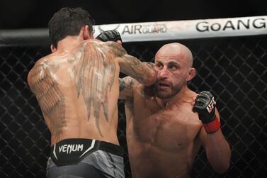 Jul 2, 2022; Las Vegas, Nevada, USA; Alexander Volkanovski (red gloves) and Max Holloway (blue gloves) fight in a bout during UFC 276 at T-Mobile Arena.  Mandatory Credit: Stephen R.  Sylvanie-USA TODAY Sports