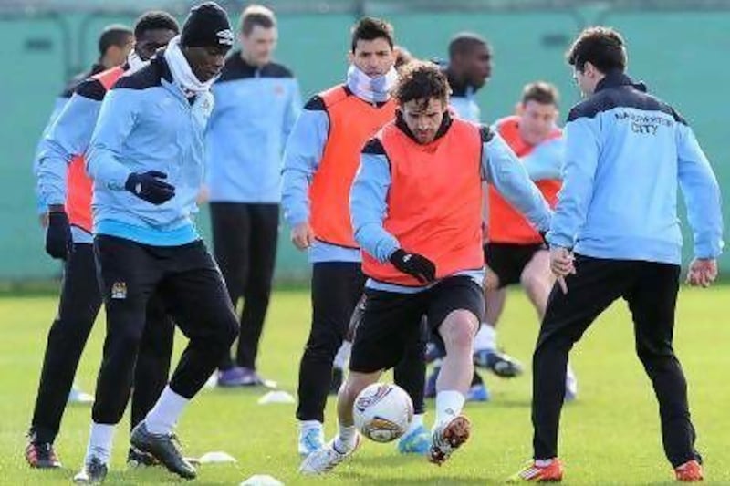 Owen Hargreaves, centre, is in the middle of the action during Manchester City's training session ahead of their Europa League match with Sporting.