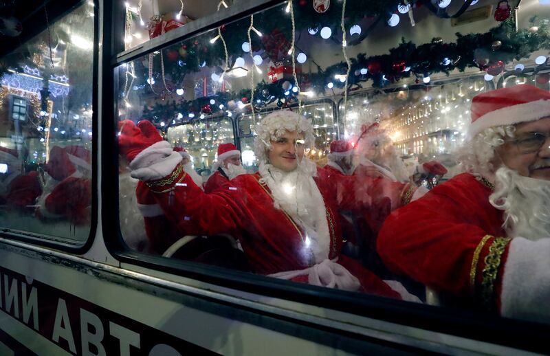 Musicians dressed as Father Frost (the Russian version of Santa Claus) take a bus along Nevsky Prospekt Avenue during festive celebrations in St Petersburg, Russia. EPA