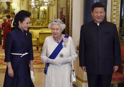 Xi Jinping and his wife Peng Liyuan accompany Queen Elizabeth II for a state banquet at Buckingham Palace in 2015. Getty Images