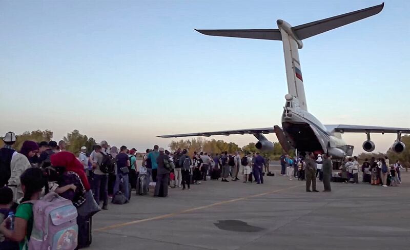 People board a Russian military aircraft during an evacuation operation at Khartoum airport on May 2. EPA