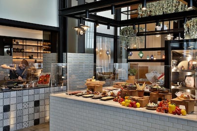 Cooking and buffet stations at Graphos Social Kitchen. Courtesy Hilton