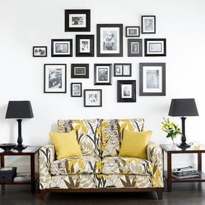 Family photographs arranged in co-ordinating black frames. Courtesy Archicture and Design.