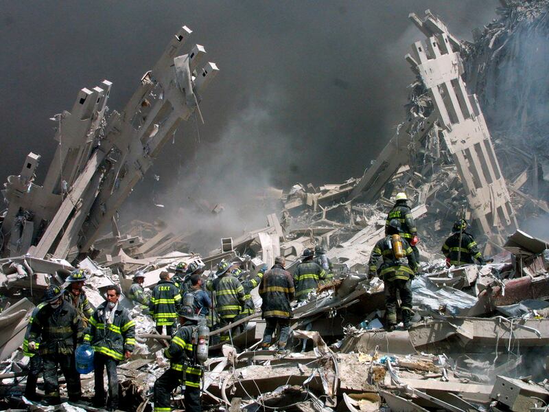 Firefighters make their way through the rubble after two airliners crashed into the World Trade Centre in New York on September 11, 2001. AP