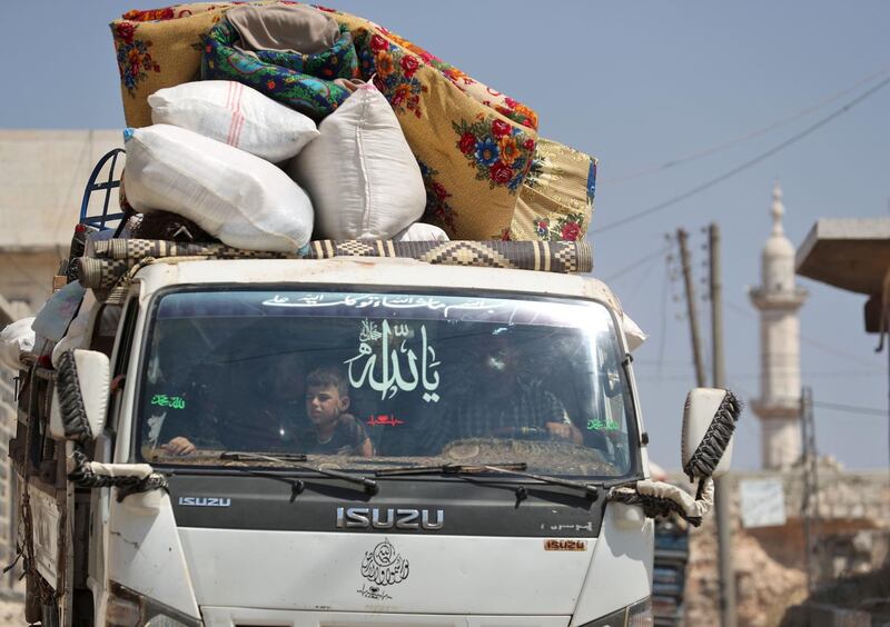 Syrian civilians flee a conflict zone in Syria's rebel-held northwestern region of Idlib, where government bombardment has killed hundreds since late April, near Maar Shurin on the outskirts of Maaret Al Numan.  AFP