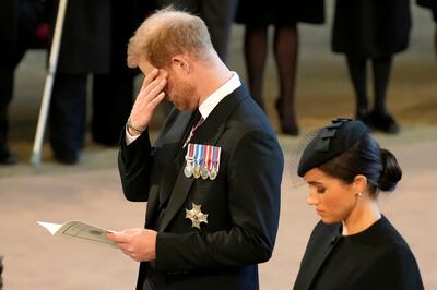 Prince Harry and his wife, Meghan, pay their respects to Queen Elizabeth II as the coffin lies in state at Westminster Hall, on September 14, 2022. AP