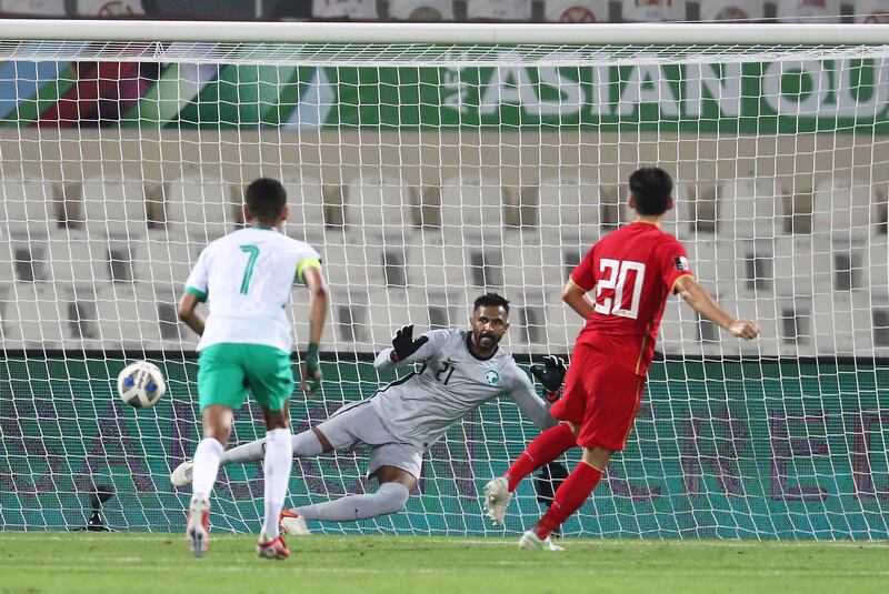 Zhu Chenjie scores an 82nd-minute equaliser from the penalty spot in the World Cup 2022 Group B qualifier between China and Saudi Arabia in Sharjah, UAE, on Thursday, March 24, 2022. Pawan Singh / The National  