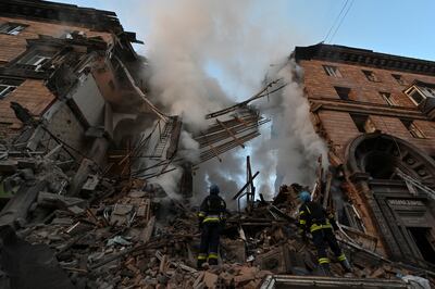 Rescuers at a residential building heavily damaged by a Russian missile strike in Zaporizhzhia. Reuters 