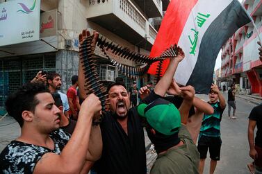 Protesters hold bullets belonging to Iraqi police during a protest in Baghdad. The Iraqi security forces clashed with anti-government protesters in the capital and other provinces Tuesday, killing and injuring civilians, according to officials. AP