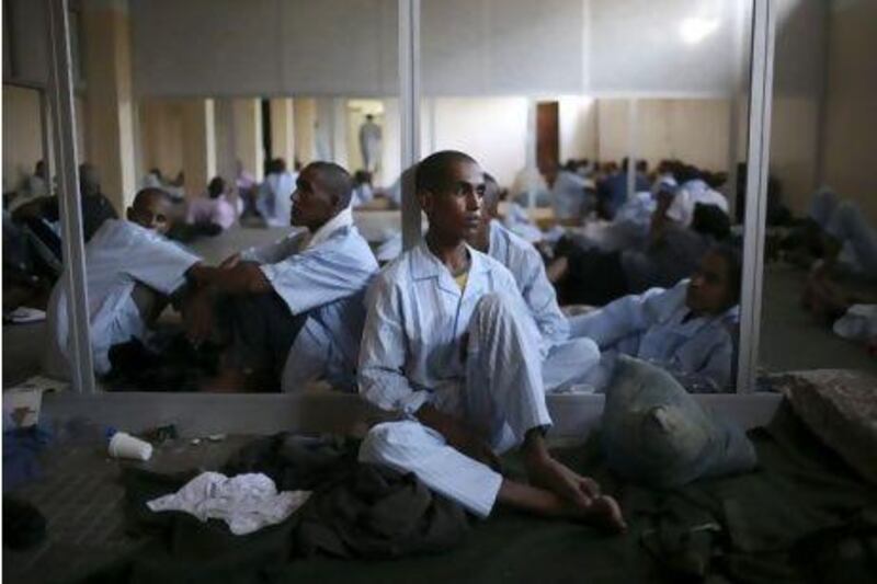 Pro-Qaddafi soldiers rest in a school converted into a prison in Tripoli, Libya.